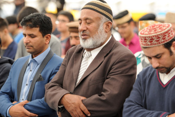 Ahmadiyya Muslims gather for Friday prayers in the main tent as they join up to 30,000 Muslims to pledge allegiance to the Caliph during Jalsa Salana UK 2014 in Alton, Hampshire.