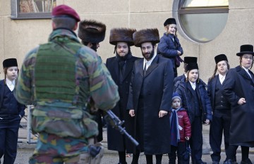 A Belgian paratrooper guards outside a Jewish school in the central city of Antwerp